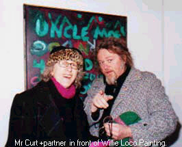 Mr Curt and wife in front of Willie Loco painting.
